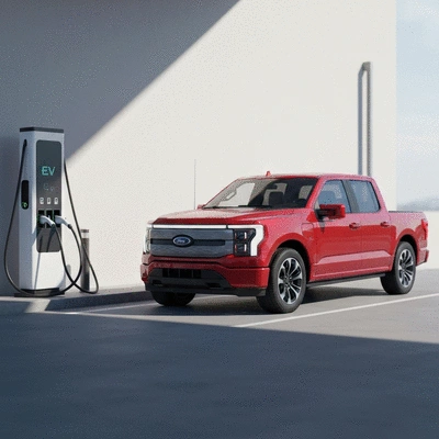 Ford F-150 Lightning parked at an EV charging station, clean image